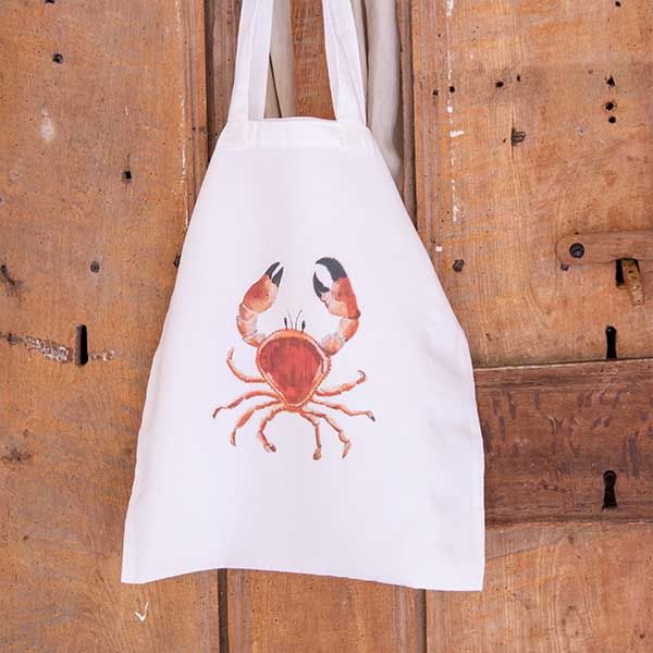 A white linen tote bag with a picture of a crab by Liz Corley Art